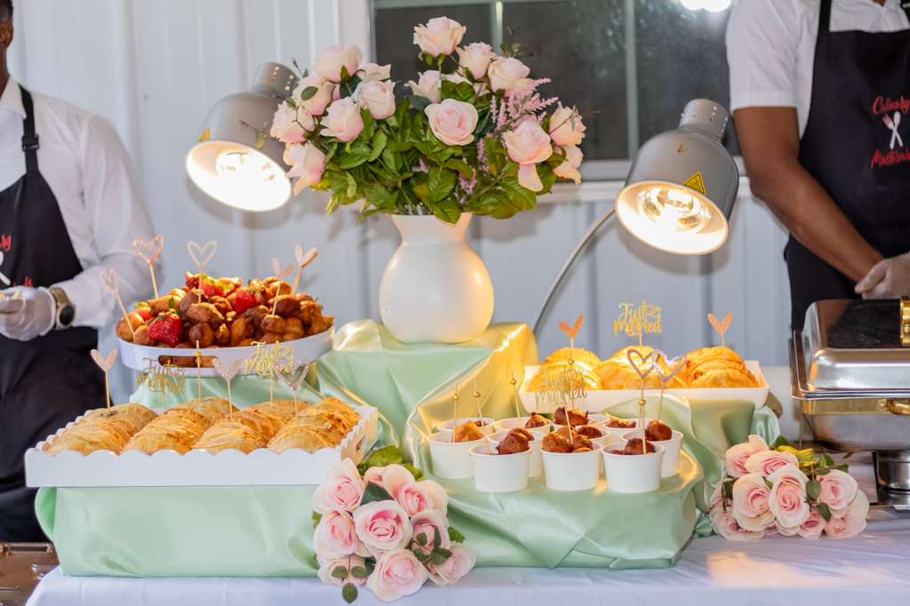 Culinary Masterminds chefs serving an elegant catered table